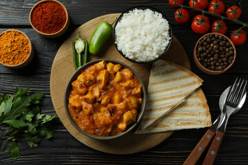 Concept of tasty food with chicken tikka on wooden background