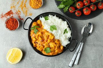 Concept of tasty food with chicken tikka on gray textured background
