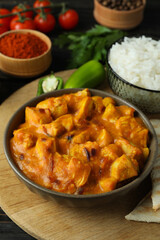 Concept of tasty food with chicken tikka on wooden background