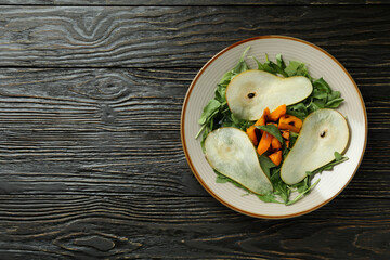 Concept of tasty food with pumpkin salad on wooden background