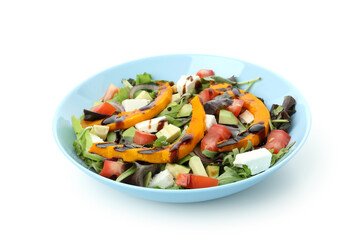 Plate with pumpkin salad isolated on white background