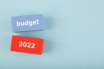 Business plan or budget concept 2022. Text budget 2022 written on red and blue rectangles on bright...
