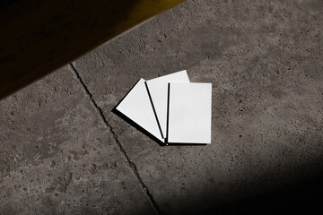 Blank business cards branding mockup templates in a modern urban environment, with deep natural...