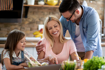 Family cooking in kitchen