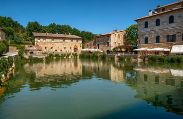 Fototapeta na wymiar Bagno Vignoni, Tuscany, Italy. August 2020. A large natural outdoor thermal hot water pool is point of interest for tourists.