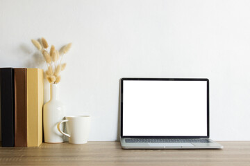 Mock up computer with nature flowers with vase and coffee mug on table. 