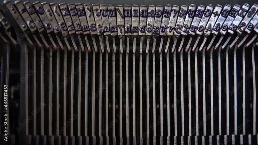 Poster mechanism of a retro typewriter. old typewriter hammers. close up. slow motion.