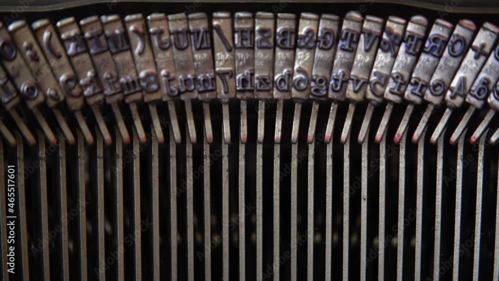 Poster mechanism of a retro typewriter. old typewriter hammers. close up. slow motion.