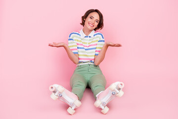 Full length photo of young girl happy positive smile shrug shoulders roller skater isolated over pastel color background