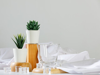 Gorgeous flower pot and empty drink glass on wooden tray with ice and cloth decoration on deluxe dining table for modern luxury spa and health care clinic