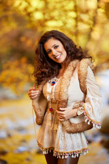 Autumn portrait with a beautiful woman in different positions near a mountain river.