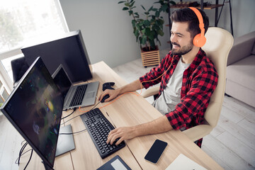 Above high angle profile side view of cheerful focused bearded guy playing video game battle at office work place space indoor © deagreez