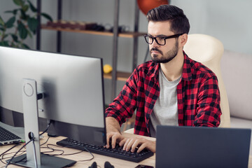 Portrait of attractive trendy skilled focused guy writing code web start-up project development at...