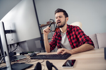 Portrait of attractive trendy focused guy writing code security data development brainstorming at...
