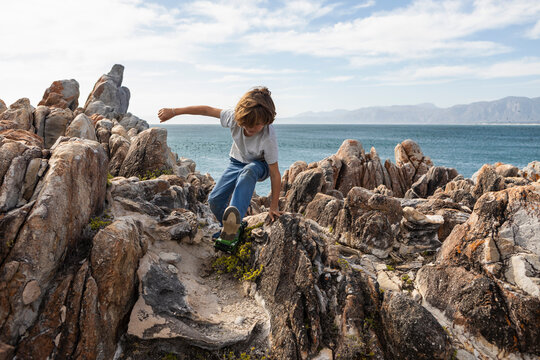 8 year old boy playing with toy safari vehicle, De Kelders,South Africa