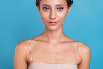 Cropped photo of attractive beautiful young lady wear beige top smiling isolated blue color...