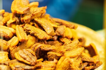 Closeup of Deep fried Pork Belly with Fish Sauce and Herb, thai street food market