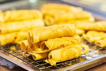 Closeup of Soft Waffle, Roll pancake stuffed, Thai dessert, background thai street food market