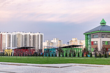 View of the kindergarten. In the background are multi-story residential buildings. Modern residential complex.