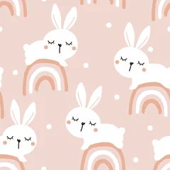 Behang Naadloze patroon met slapende konijntje op de regenbogen en stippen op roze achtergrond vector. Leuke kinderachtige print. © Thanawat