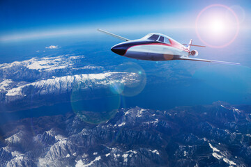 Business jet airplane fly over Alps high mountains