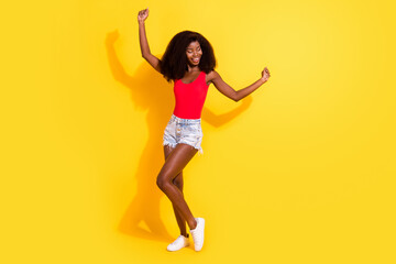 Fototapeta na wymiar Full length body size view of attractive cheerful dreamy carefree girl posing dancing isolated over bright yellow color background