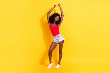 Full length body size view of attractive cheerful girl dancing having fun isolated over bright yellow color background