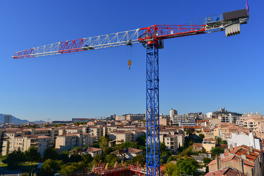 Construction crane in the blue sky of Marseille.
