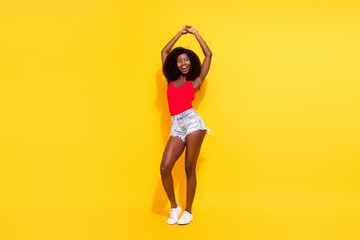 Fototapeta na wymiar Full length body size view of pretty cheerful girl dancing having fun clubbing event isolated over bright yellow color background
