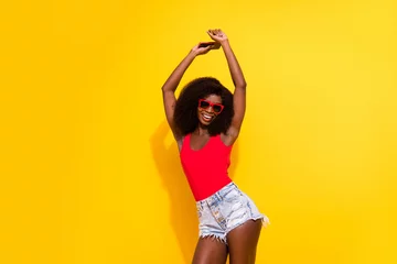 Poster Portrait of attractive cheerful girl having fun dancing vacation holiday rest relax isolated over bright yellow color background © deagreez