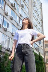 White european young girl with dark hair with buildings behind