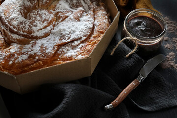 Ensaimada, a pastry typical of Mallorca, Spain, on a dark background