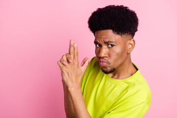Fototapeta na wymiar Portrait of attractive cool funky guy showing gesture like gun copy space isolated over pink pastel color background