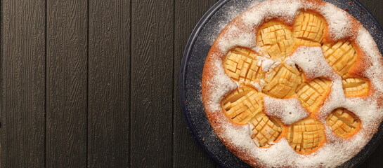 A delicious whole apple pie with powdered sugar