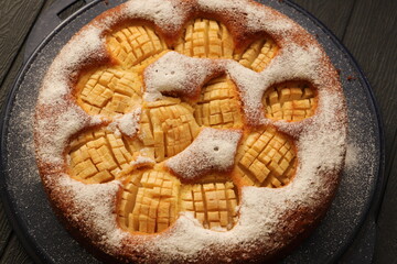 A delicious whole apple pie with powdered sugar