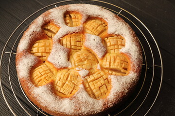 A delicious whole apple pie with powdered sugar