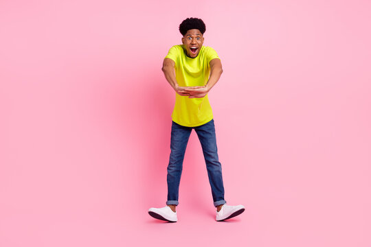 Full length photo of young excited afro guy happy positive smile have fun isolated over pink color background