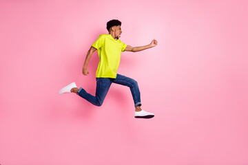 Fototapeta na wymiar Full length body size profile side view of nice purposeful guy jumping running active isolated over pink pastel color background