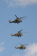 A group of Mi-35M and Mi-24 attack combat helicopters in the sky over Moscow's Red Square during the dress rehearsal of the Victory Air Parade