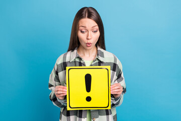 Photo of amazed shocked young woman hold hands danger sign attention isolated on blue color...