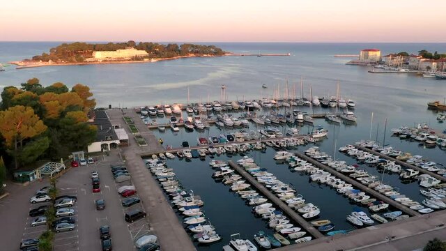 Drone video of a flight over the harbor of the Croatian coastal town of Porec during sunrise