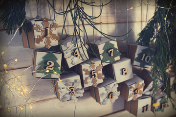 Homemade small carton boxes for advent surbrises with fairy light. Hanging vintage advent calendar...