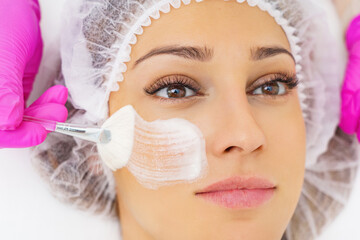  Woman in mask on face in spa beauty salon.