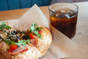 Delicious italian pizza with cola soda with ice.