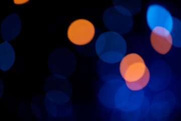 Multiple mostly blue bokeh elements in a dark environment