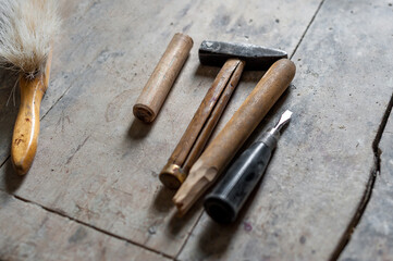 Hammer, brush, twist, old wooden table. Tools on a wooden table.