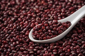 Raw adzuki red bean as background with spoon.