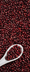 Raw adzuki red bean as background with spoon.
