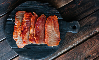 Dried chicken cut into slices on a wooden board. High quality photo
