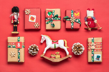 Handmade wrapped red, green gift boxes decorated with ribbons, snowflakes and numbers, Christmas decorations and decor on table Xmas advent calendar concept Top view Flat lay Holiday card